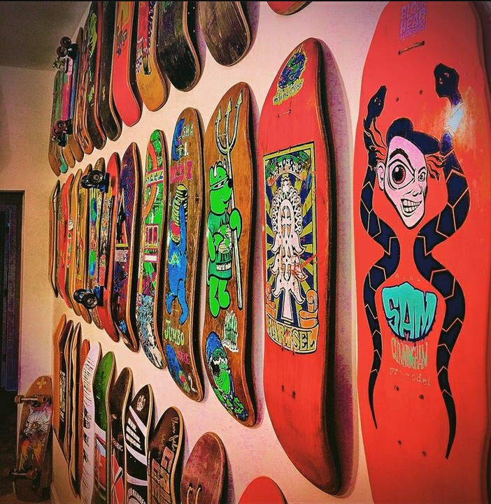 Another wall of Johnny's Skateboard collection